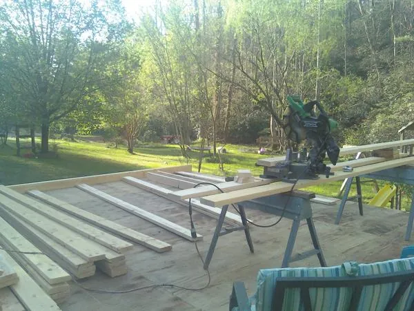 Miter saw and framing lumber on a deck under construction in Two Rivers